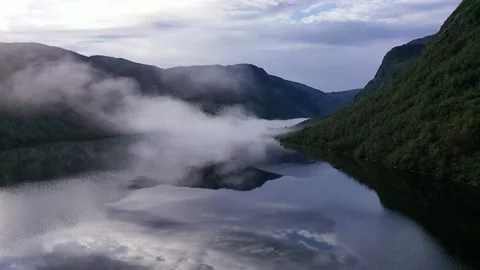 Flying trough clouds over lake in mountain Stock Footage 162388613