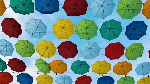 Flying Umbrellas. Multi colored Parasol Soar in the Sky. Umbrellas Suspended Stock Footage 97358169