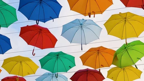 Flying Umbrellas. Multi colored Parasol Soar in the Sky. Umbrellas Suspended Stock Footage 97378347