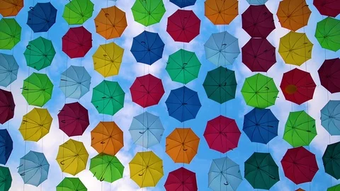 Flying Umbrellas. Multi colored Parasol Soar in the Sky. Umbrellas Suspended Stock Footage 97378876