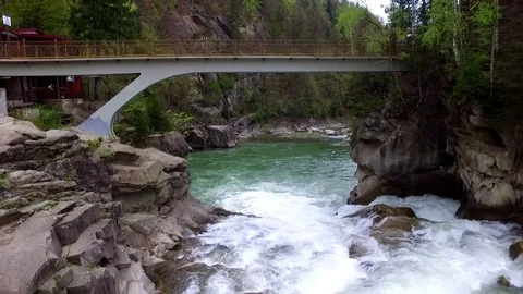Flying under the bridge above waterfall Stock Footage 73095380