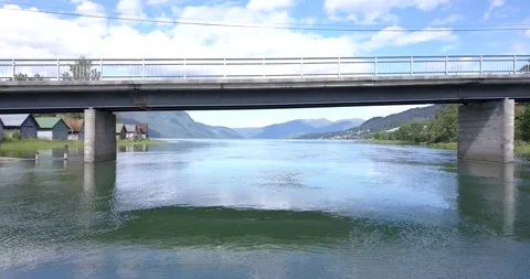 Flying under bridge against river and sea Stock Footage 159010890
