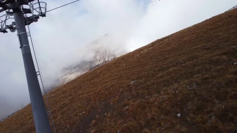 Flying under the cable road in Swiss Alpes Stock Footage 228841340