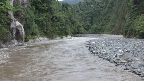 Flying under a fast flowing river under a small bridge Stock Footage 143676428