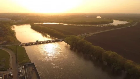 Flying under river and bridge. aerial view. sunset panorama. crossing bridge Video stock 75414344