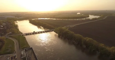 Flying under river and bridge. aerial view. sunset panorama. crossing bridge Stock Footage 75414650