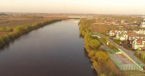 Flying under river and bridge. aerial view. sunset panorama. crossing bridge Stock Footage 75418802