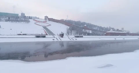 Flying under the river, walls and towers of the Nizhny Novgorod Kremlin. Dawn ov Stock Footage 85700189