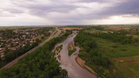 Flying Upstream Over River and Road Color Corrected Stock Footage 98846382