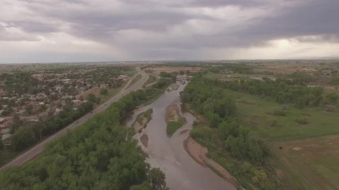 Flying Upstream Over River and Road Stock Footage 98846392