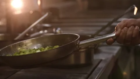 Flying vegetables fried on pan, chef throwing food, tossing ingredients. Close Vídeos de archivo 150400189