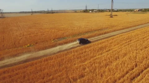 Flying vertically above car driving on road 库存影片 61147644