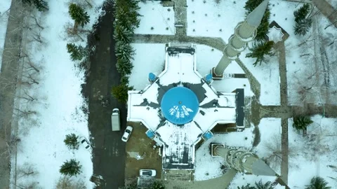 Flying vertically down on a drone over a mosque with a blue dome, winter Kazakhs Stock Footage 240530944