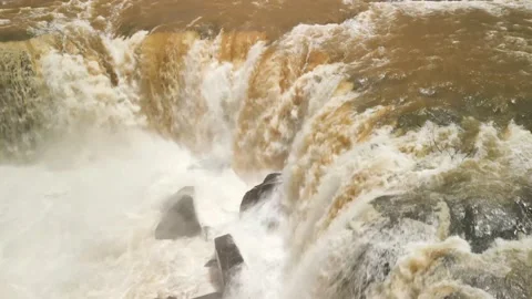 Flying very close to a waterfall in a rushing river. Salto Saudades. 4K. Video stock 233219683