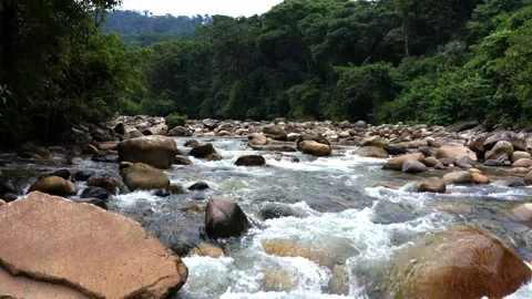 Flying very low over a mountain river full of large boulders Stock Footage 151277911