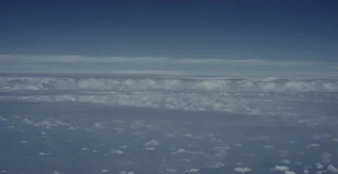Flying view from airplane window of clouds on a perfect day Stock Footage 223489397