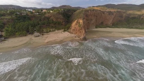Flying on a virgin beach cliff Stock Footage 78953510