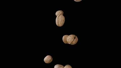 Flying walnuts on a black background. Super slow motion. Видео 149177437