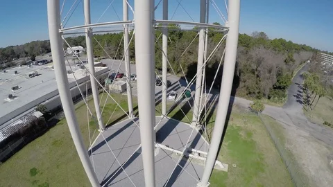Flying up water tower from ground level to the top to reveal the Panama City Stock Footage 90562863
