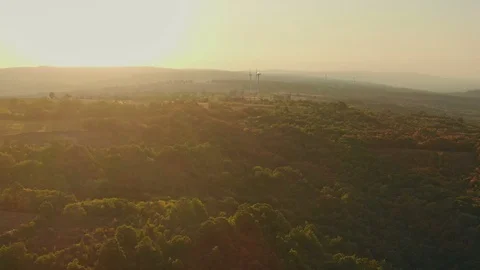 Flying to Wind turbines generating renewable, sustainable energy in mountains Video stock 115989319