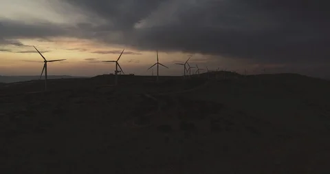 Flying by the wind turbines right before the dark 4K Stock Footage 103790766