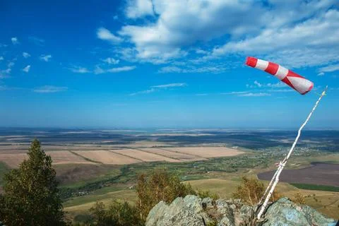 Flying windsock wind vane Flying windsock wind vane on mountine backgound,... Stock-Fotos