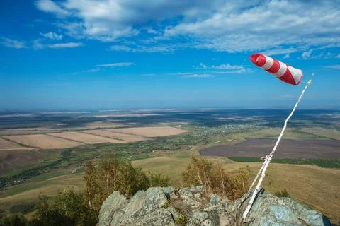 Flying windsock wind vane Flying windsock wind vane on mountine backgound,... Stock-Fotos
