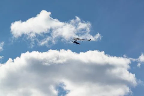 Flying wing in the sky with clouds. Stock Photos