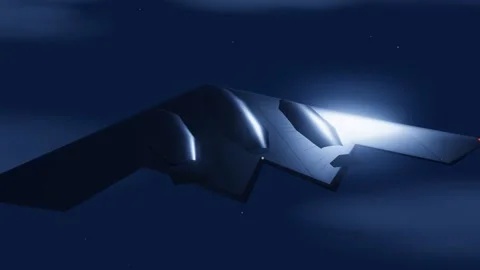 Flying-wing stealth bomber cruising through a moonlit night sky on a long-range Stock-Footage 340875866