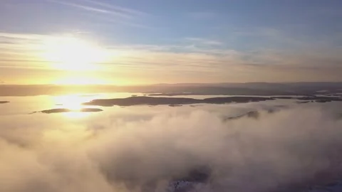 Flying on a winter day in the sun above low clouds Stock Footage 143552306