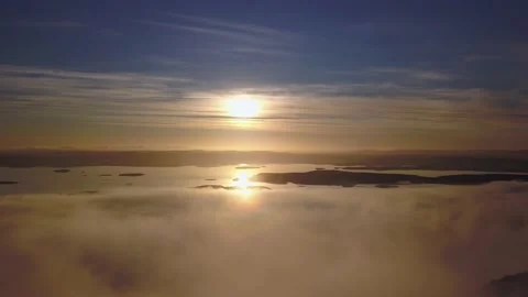 Flying on a winter day in the sun above low clouds Stock Footage 143575552