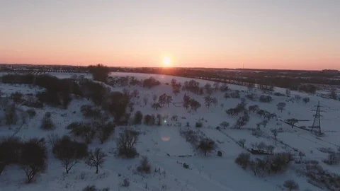 Flying in winter over snowy hills beautiful sun at sunset cold frosty evening Stock Footage