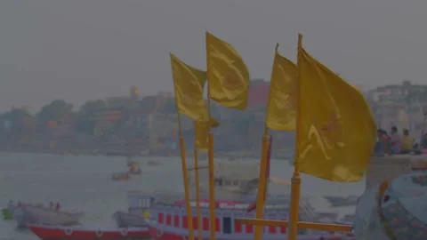 Flying yellow flags at Varanasi Ghat in india Stock Footage 220906222
