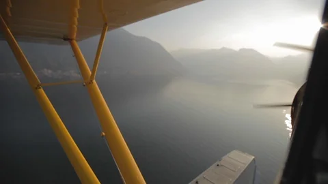 Flying in the yellow floatplane low over Lake como. View from the cabin Video stock 127823160
