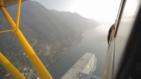 Flying in the yellow floatplane over Lake como. View from the cabin Video stock 127823260