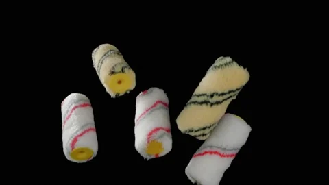 Flying yellow paint rollers on a black background. Repair tool. Super slow Видео 149177605