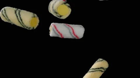 Flying yellow paint rollers on a black background. Consumables for repair. Super Stockbeeldmateriaal 149242098
