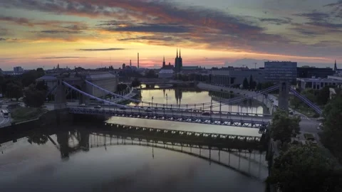 Flyingover Oder river to Grunwaldzki Bridge in Wrocław. Passing bye trafffic Stock Footage 135848426