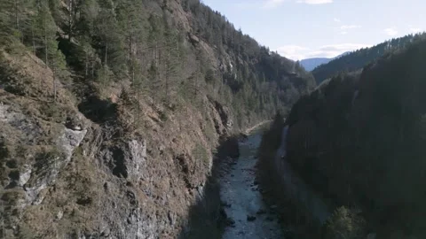 A flyover of an alpine river, captured in D-Log for flexible post-production Stock Footage 301605439