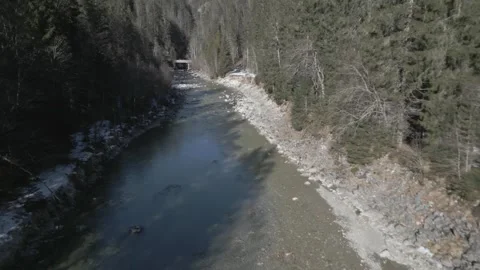 A  flyover of an alpine river, captured in D-Log for flexible post-production 動画素材 301605862