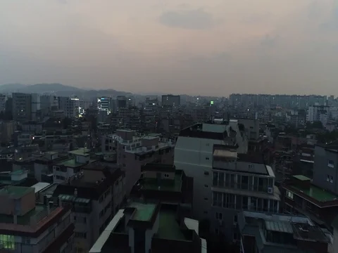 Flyover of apartment buildings at dusk in Seoul Stock Footage
