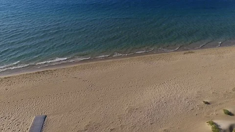 Flyover beach ocean tracking and pan tourism holiday aerial footage Stock Footage 100008715