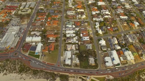 Flyover a beachside suburb next to blue ocean and reef aerial footage 4k Stock Footage 98185392