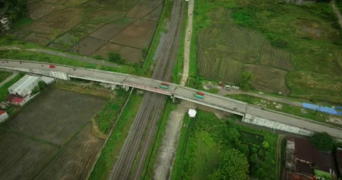 Flyover Bridge Over Rice Fields - Aerial Drone Shot Stock Footage 309124631