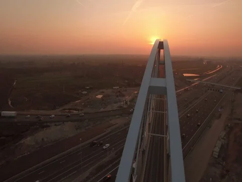 Flyover bridge, sunset with traffic at over a highway Stock Footage 80863035