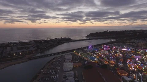 Flyover carnival to ocean at sunset Stock Footage 125773769
