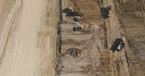 Flyover Construction Site with Bulldozer &amp; Dump Trucks Stock Footage 301668684