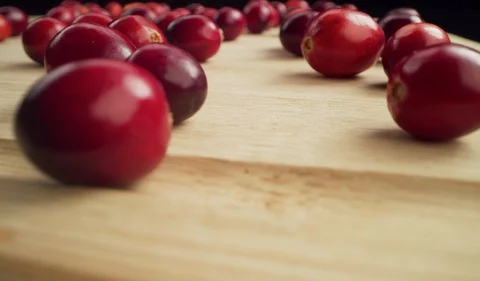 Flyover of Cranberries on Cutting Board on Black Background Macro 4K Stock-Footage 120356953