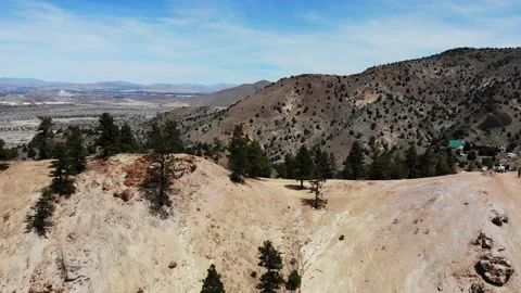 Flyover desert mountain and trees toward city of Reno Stock Footage 134581742
