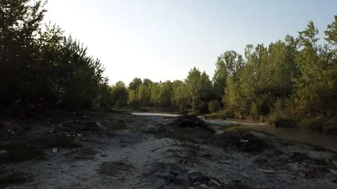 Flyover dry polluted river bed sunset Video stock 111298739